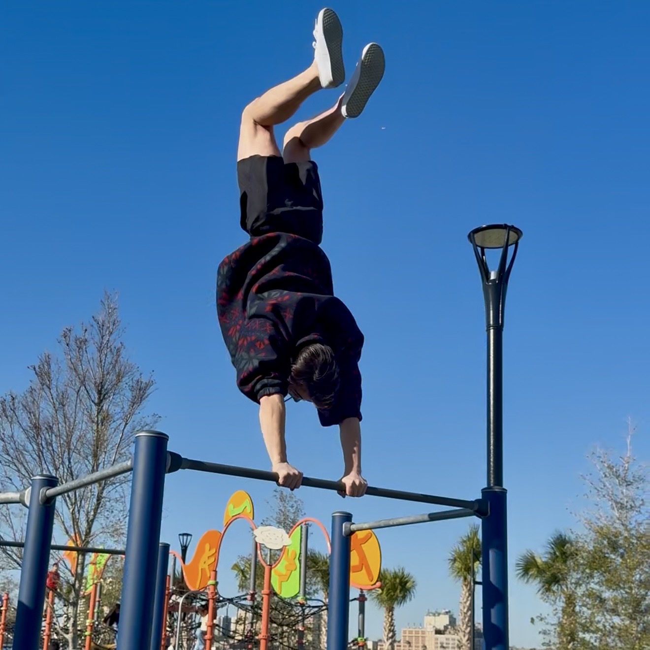 JaxBars athlete holding a handstand on bars